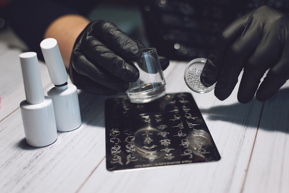 Nail Art Stamping process. Manicure master makes Stamping